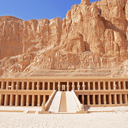 The Mortuary Temple of Hatshepsut with its grand colonnade and staircase set against towering cliffs.