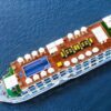 Aerial view of a cruise ship with a pool and sun loungers on the deck, sailing on blue water.